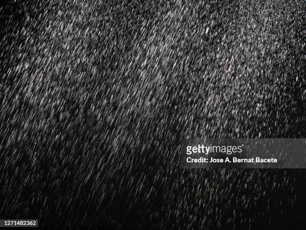water drops falling on a black background. - torrential rain stock pictures, royalty-free photos & images
