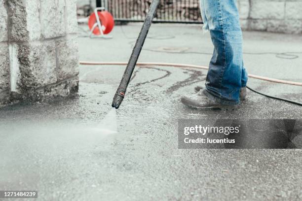 pressure washer used to clean driveway - moss stock pictures, royalty-free photos & images
