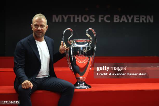 Hans-Dieter Flick, head coach of Bayern Muenchen, hands over the UEFA Champions League trophy to the FC Bayern Museum on September 09, 2020 in...