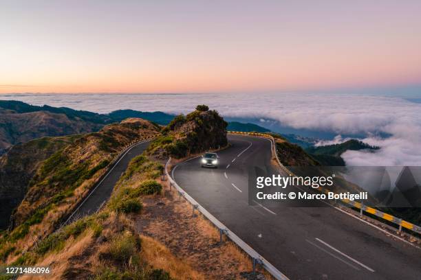 car driving on winding mountain road, madeira island, portugal - straßenverkehr stock-fotos und bilder