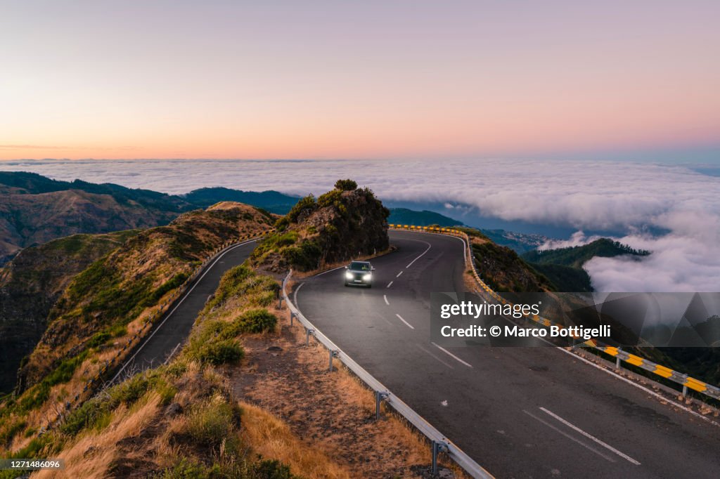 Car driving on winding mountain road, Madeira island, Portugal