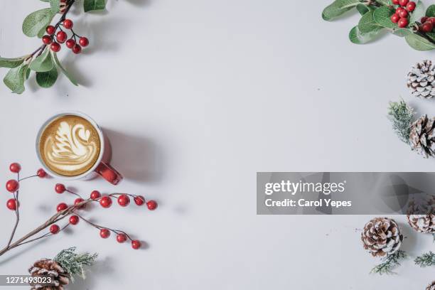 coffee cup with christmas ornaments and decoration on white background - table decoration stockfoto's en -beelden