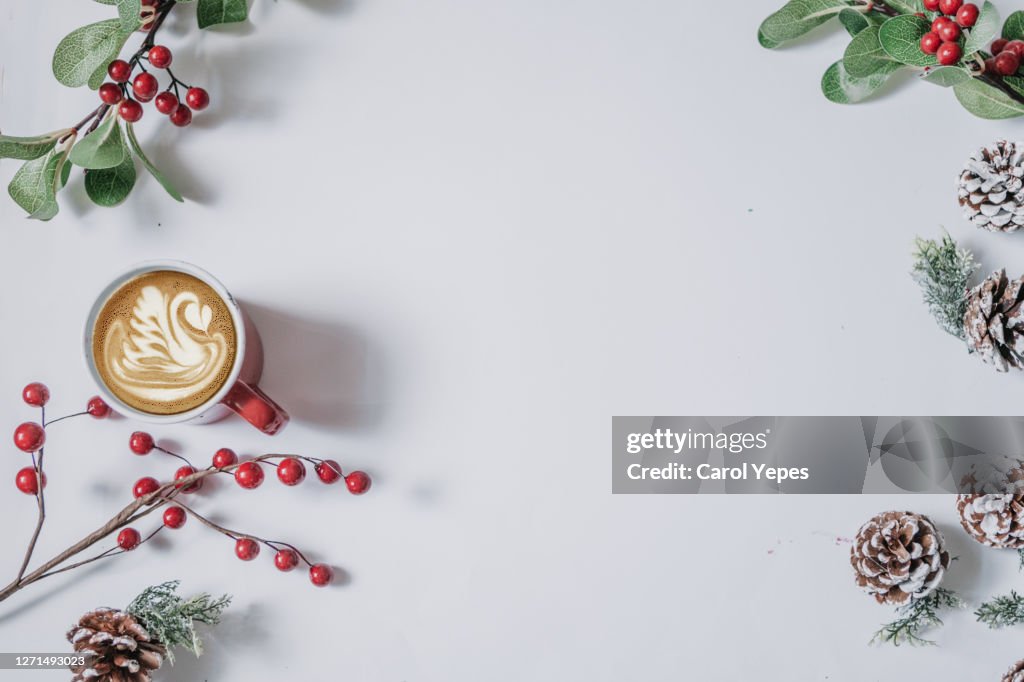 Coffee cup with Christmas ornaments and decoration on white background