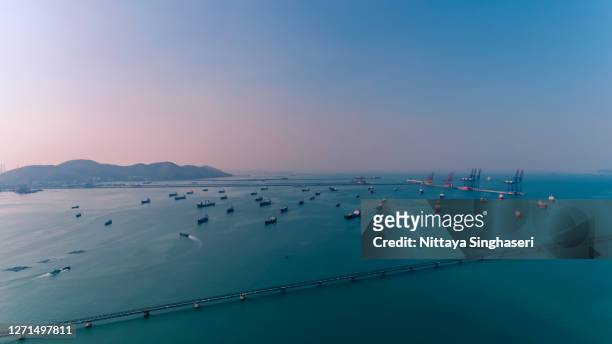 aerial view of many oil tankers moored around oil port in the evening. - tank barge stock pictures, royalty-free photos & images