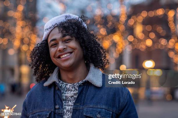 one male mixed race student at christmas - netherlands christmas stock pictures, royalty-free photos & images