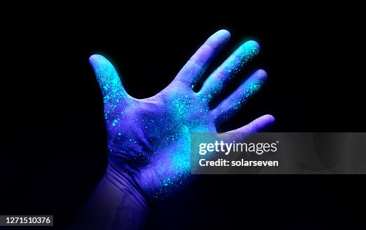 Ultraviolet Light On a Hand Showing Bacteria Growth Ultraviolet Light On a Hand Showing Bacteria Growth