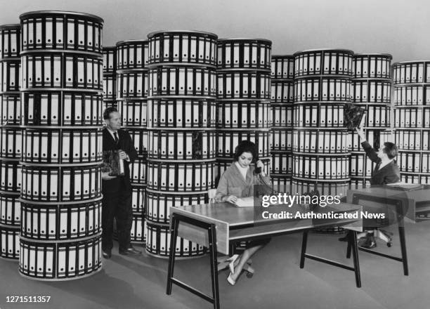 Column Files An office worker retrieves files from innovative rotating file... News ...
