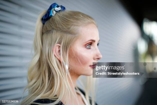 Half ponytail hairstyle with a sustainable scrunchie made out of old Hermes scarfs by James as a detail of german model Anna Hiltrop during a street...