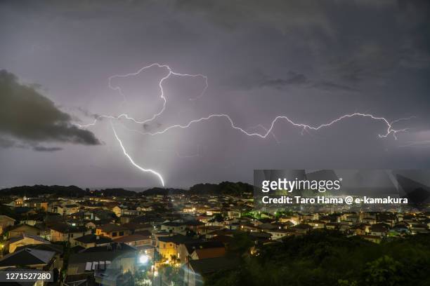 thunder clouds on the residential district by the sea in kanagawa prefecture of japan - kanagawa stockfoto's en -beelden