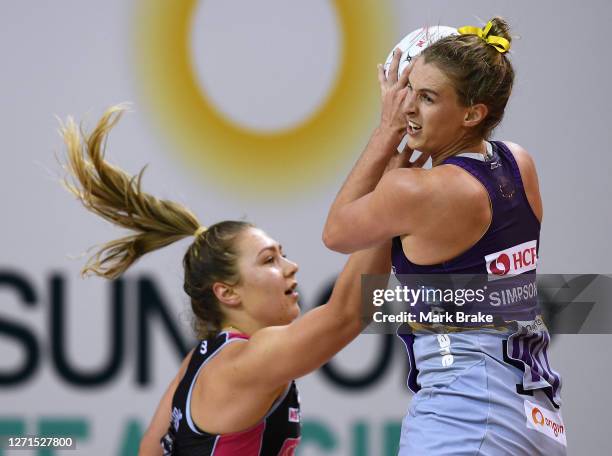 Gabi Simpson of the Firebirds catches the ball over Georgie Horjus of the Thunderbirds during the round 11 Super Netball match between the Adelaide...