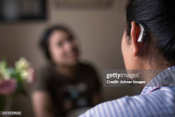 close-up of woman with hearing aid - hearing aids stock pictures, royalty-free photos & images