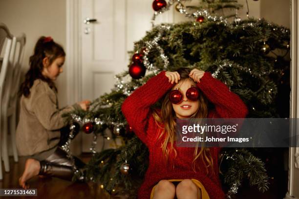 girl in front of christmas tree - johner christmas bildbanksfoton och bilder