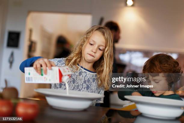 children having breakfast - milk pour - fotografias e filmes do acervo