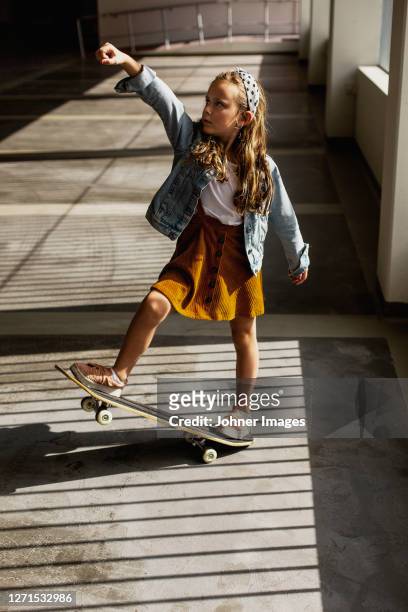 view of girl on skateboard - children only stock-fotos und bilder