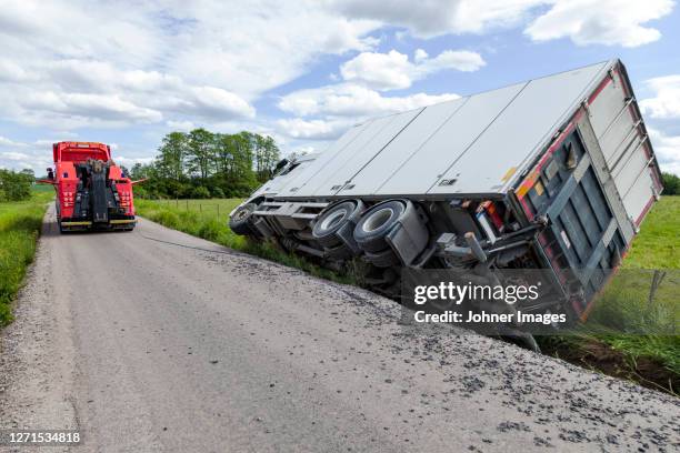 overturned lorry on road side - wreck stock pictures, royalty-free photos & images