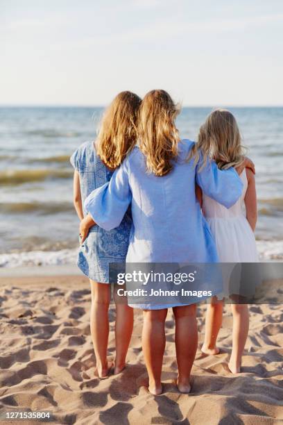 mother with daughters on beach - long white beach dress stock pictures, royalty-free photos & images