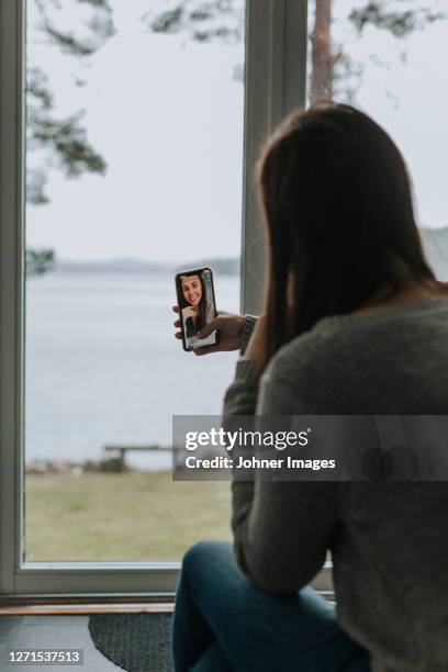 smiling woman taking selfie - lighting technique stock pictures, royalty-free photos & images