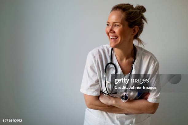 female doctor looking away - european doctor bildbanksfoton och bilder