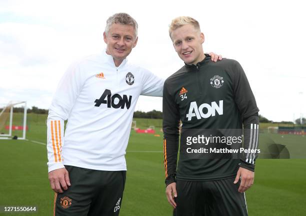 Donny van de Beek of Manchester United poses with Manager Ole Gunnar Solskjaer after a first team training session at Aon Training Complex on...
