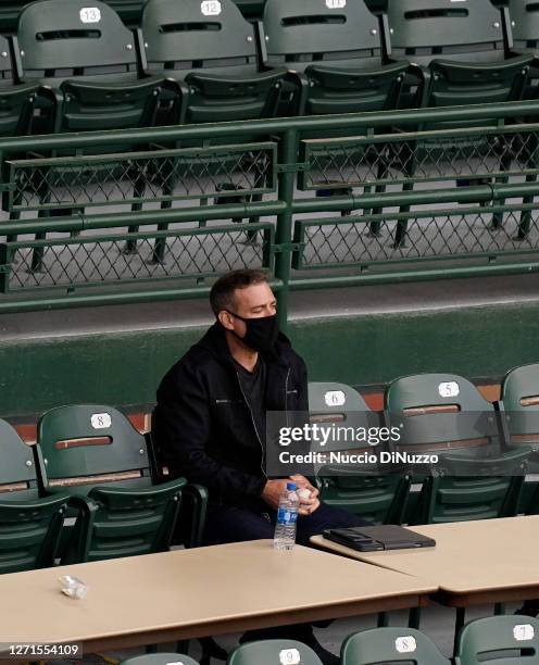 President of baseball operations Theo Epstein of the Chicago Cubs watches the game between the Chicago Cubs and the St. Louis Cardinals at Wrigley...