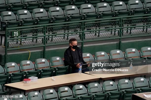 President of baseball operations Theo Epstein of the Chicago Cubs watches the game between the Chicago Cubs and the St. Louis Cardinals at Wrigley...