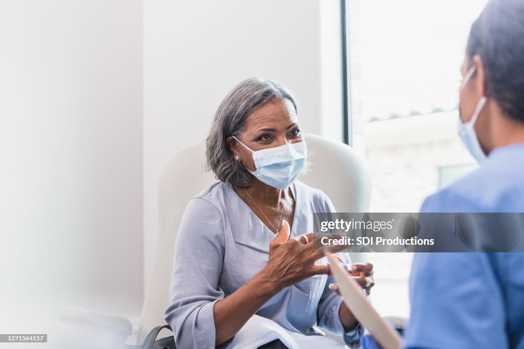 Senior adult patient talks with doctor