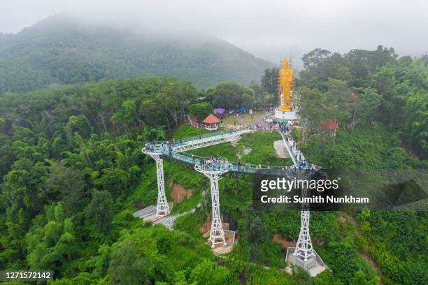chiang khan, loei, thailand - 05 september 2020 : aerial top view of beautiful white bridge or glass sky walk is new landmark viewpoint bettween thailand and laos pdr at phra yai phu khok ngio chiang khan, loei province, mekong river thailand - hunan province stock pictures, royalty-free photos & images