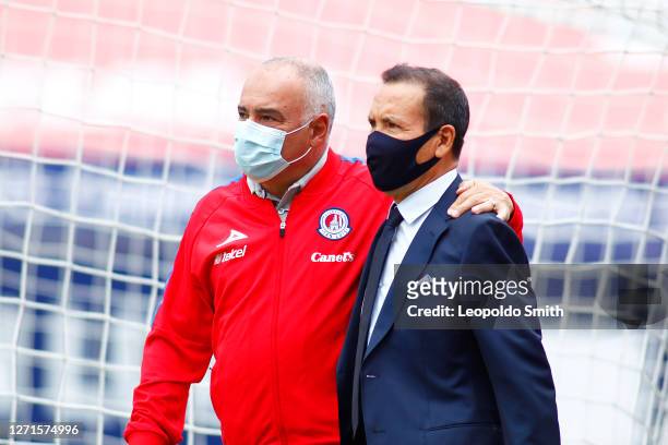 Guillermo Vazquez coach of Atletico San Luis and Jose Guadalupe Cruz coach of Necaxa enter the field prior the 9th round match between Atletico San...