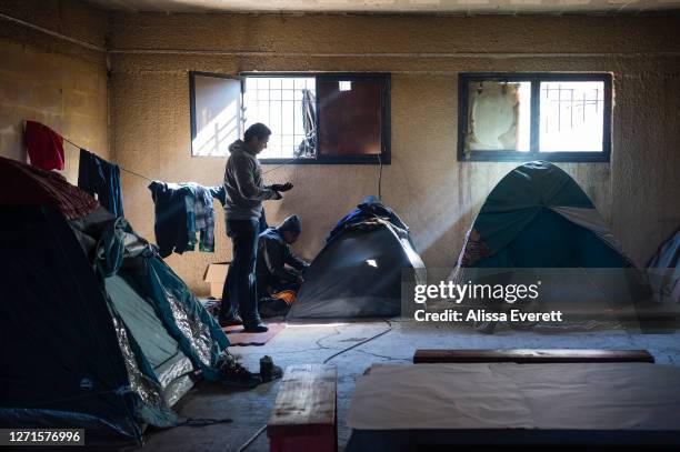 Refugees leave tough conditions in Moira Refugee Camp to find alternative living situations in derelict buildings on January 28, 2017 in Mytilene,...