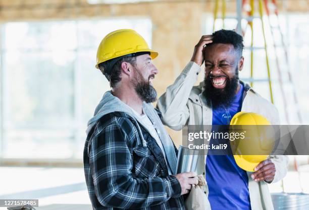 two construction workers in building, taking a break - coworkers laughing stock pictures, royalty-free photos & images