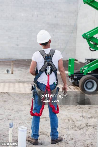 construction worker wearing safety hardness, on ground - safety harness stock pictures, royalty-free photos & images