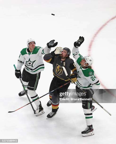Denis Gurianov and Roope Hintz of the Dallas Stars along with Mark Stone of the Vegas Golden Knights attempt to corral the puck in Game Two of the...