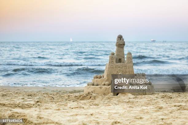 sand castle on the beach - sandburg stock-fotos und bilder