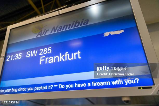 Sign asking "Do you have a firearm with you?" is displayed at a flight to Frankfurt, Germany, on a screen at the airport of Windhoek, Namibia, on...