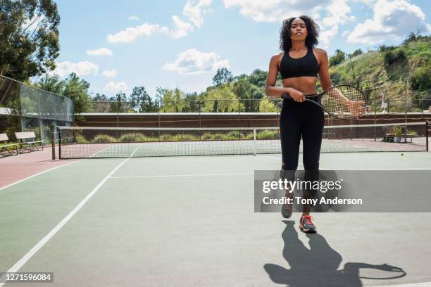 young woman on tennis court - championship round one stock-fotos und bilder