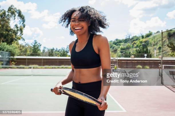 young woman on tennis court - tennis women ストックフォトと画像