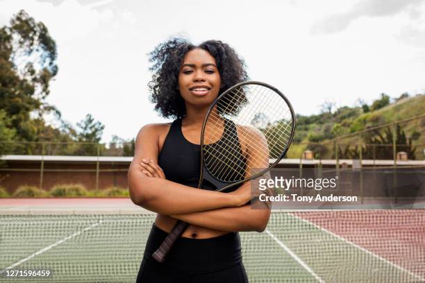 young woman on tennis court - match sport stock-fotos und bilder
