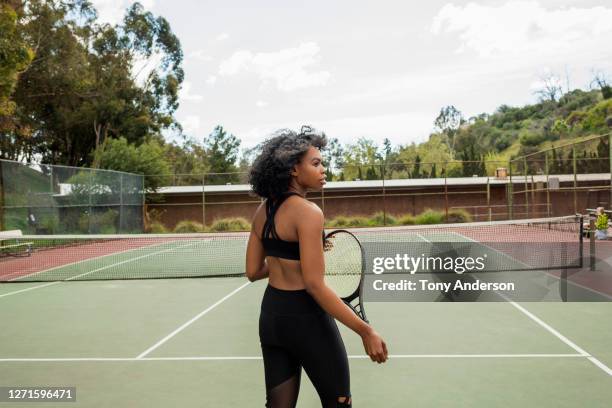 young woman on tennis court - racquet sport stock pictures, royalty-free photos & images