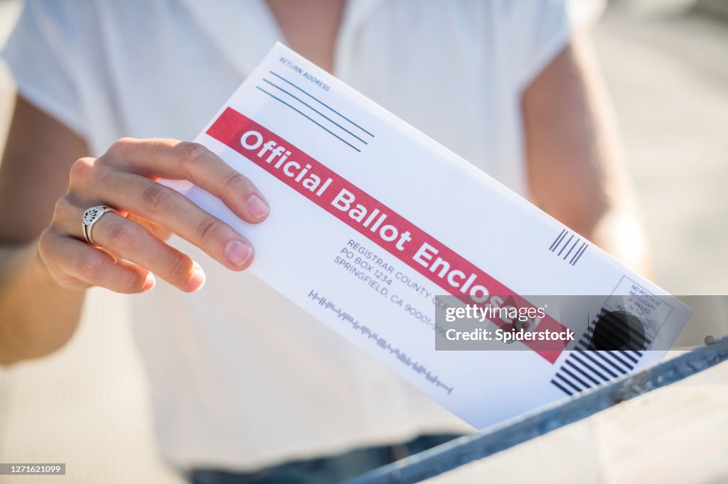 Woman Mailing Her Absentee Voter Ballot