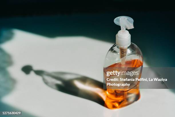 bottle of hand wash casting a shadow - soap dish stock pictures, royalty-free photos & images