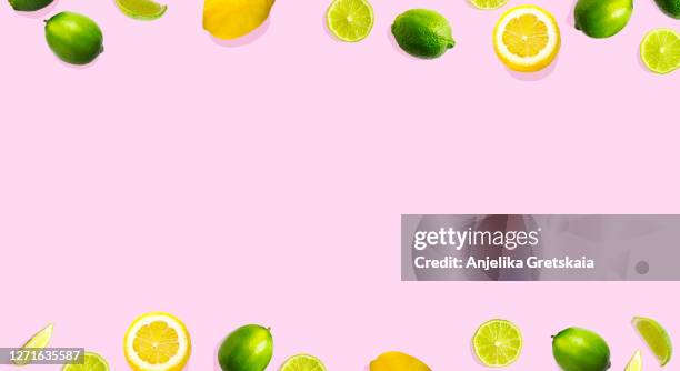 frame of lime and lemon on pink background. - lime overhead stock pictures, royalty-free photos & images