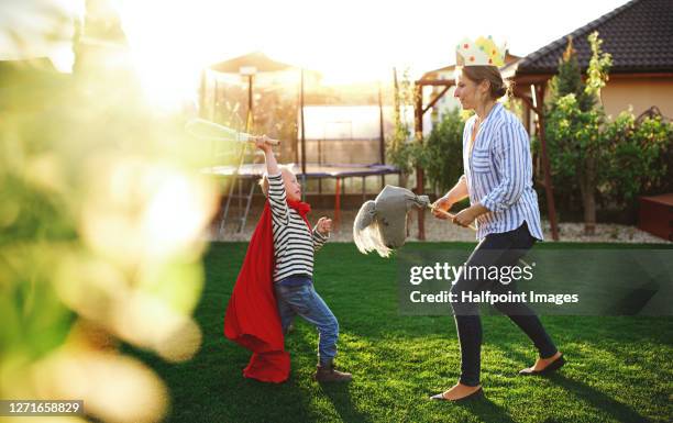 happy mother playing with down syndrome son outdoors in garden. - horses playing stock pictures, royalty-free photos & images