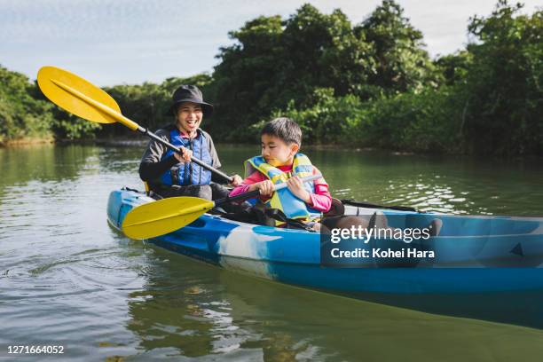 mother and son enjoying kayaking in the river - japan mom and son stock pictures, royalty-free photos & images