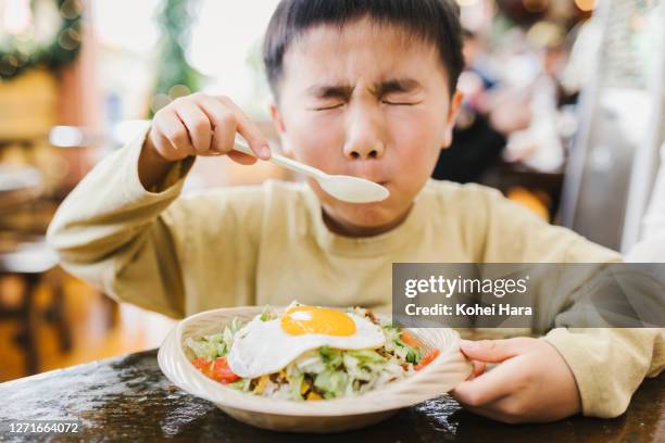 boy eating taco rice in okinawa - japan food stock pictures, royalty-free photos & images