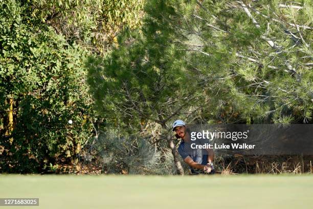 Tommy Fleetwood of England chips onto the 5th green during Day One of the Portugal Masters at Dom Pedro Victoria Golf Course on September 10, 2020 in...