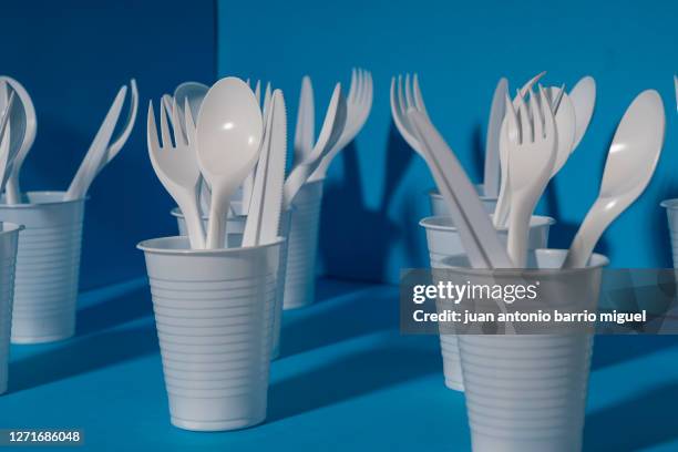 disposable plastic tableware. environmental problem, environmental pollution. on a blue background. - plastic fork stock pictures, royalty-free photos & images
