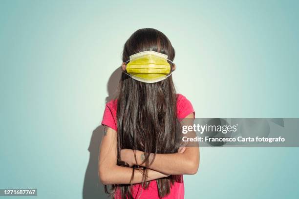 children and bizarre social distancing - funny surgical masks stockfoto's en -beelden