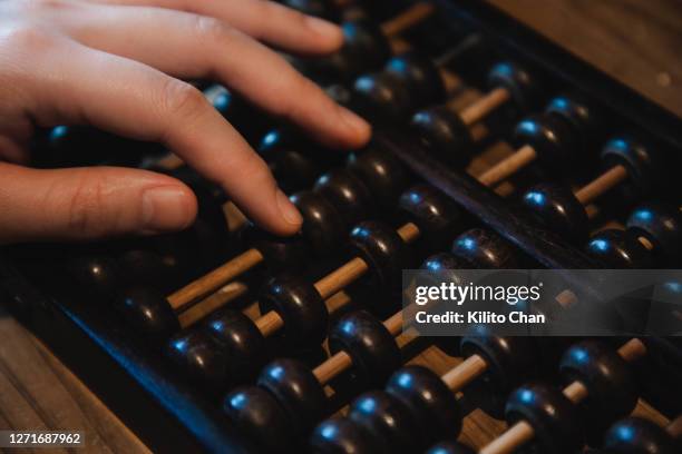 female hand using chinese abacus - accounting abacus stock pictures, royalty-free photos & images