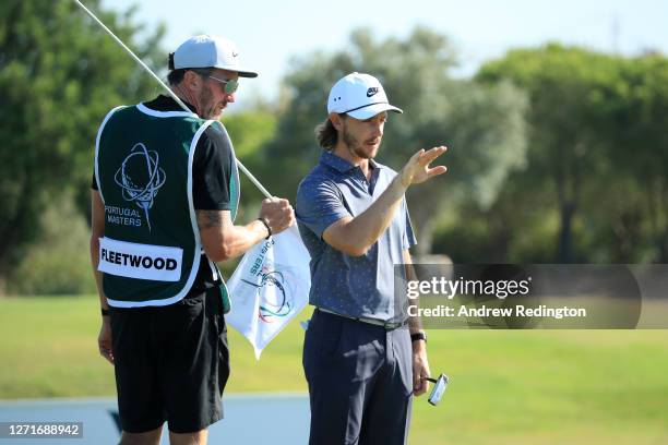 Tommy Fleetwood aof England and his caddie look on on the 8th hole during Day One of the Portugal Masters at Dom Pedro Victoria Golf Course on...