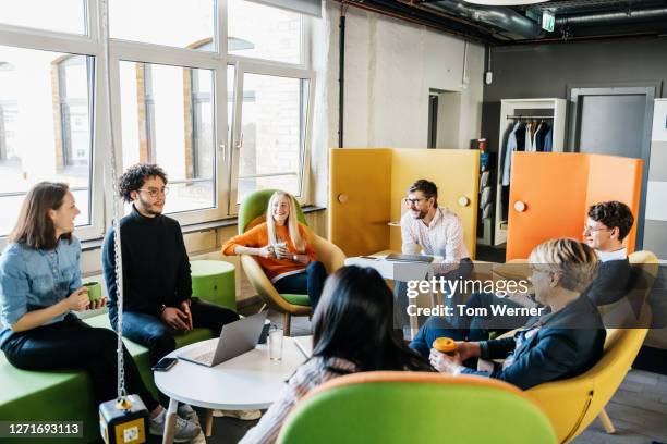 group of employees brainstorming during seminar - mesa redonda imagens e fotografias de stock